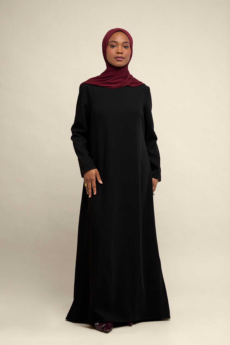 Elevate your modest wardrobe with our elegant two-piece staple abaya set in black. This versatile set includes a long-sleeve dress with a discreet back zipper and a classic abaya overlay that drapes beautifully for a timeless look.