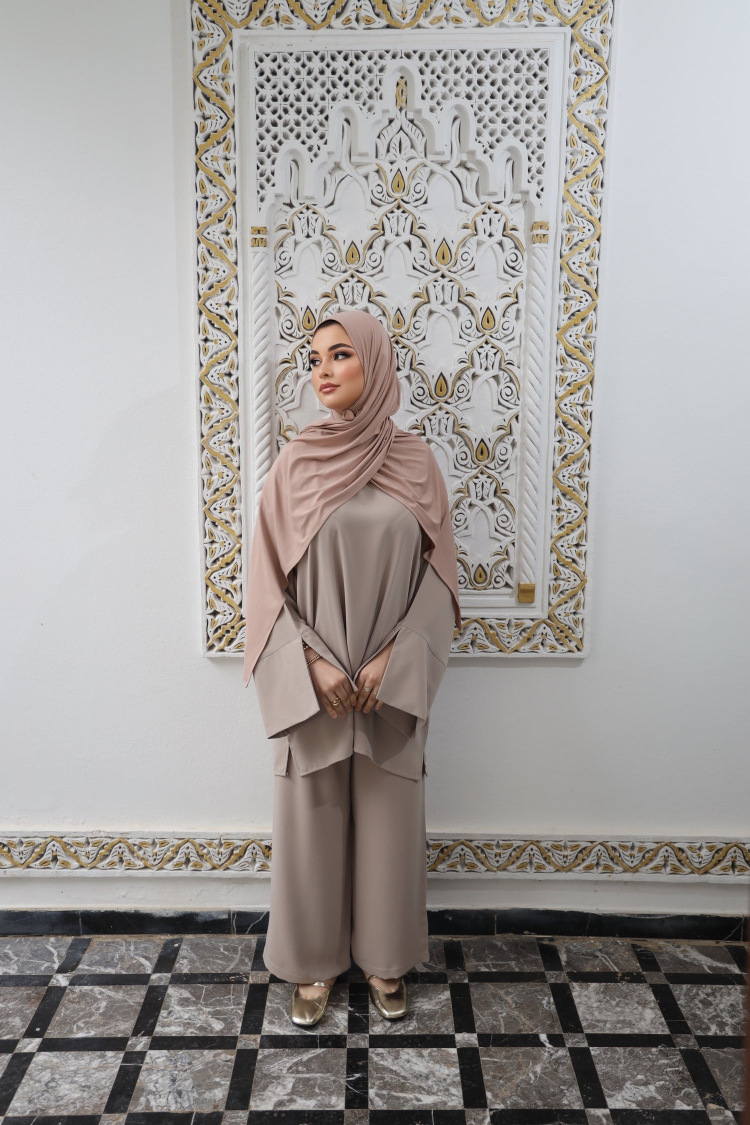 Full outfit view of a woman wearing a matching Taupe tunic and wide-leg trousers.