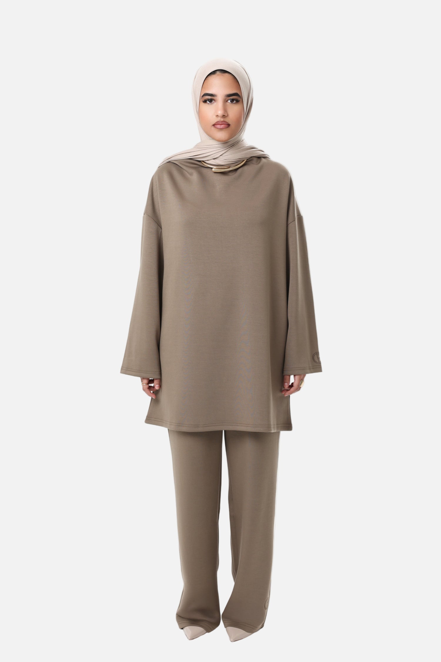 Model wearing the CHANO Comfy Two-Piece Set in Taupe — an oversized tunic with wide sleeves and matching wide-leg trousers, styled with a beige hijab.