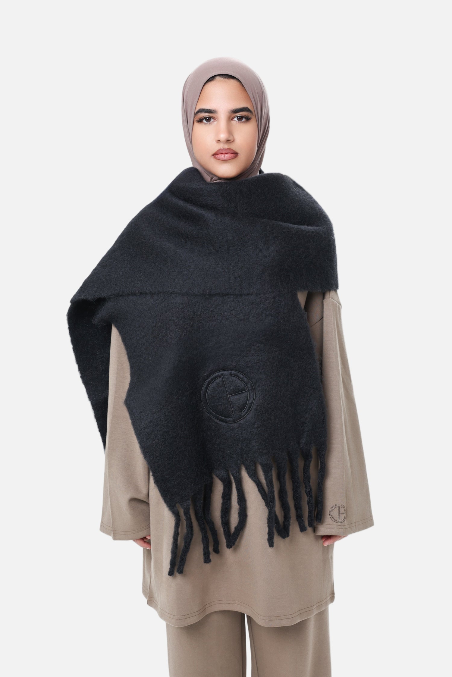Front view of the Comfy Scarf in Black styled with a taupe hijab and modest outfit, highlighting the brushed fabric and CHANO Modesty embroidery.