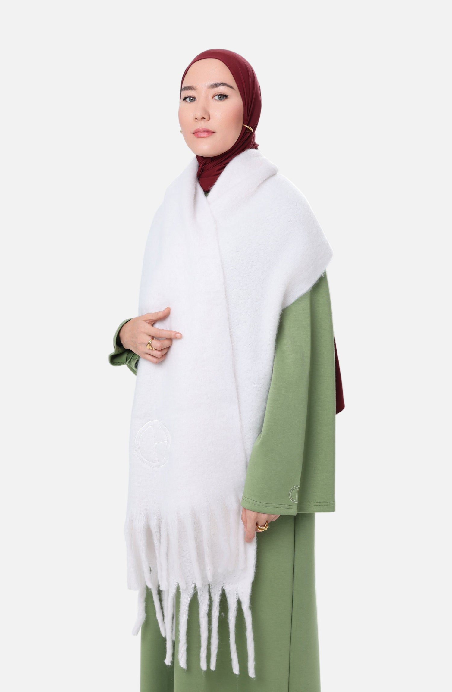 Side view of the Comfy Scarf in Ivory paired with a Leaf modest outfit, highlighting the oversized design and tone-on-tone embroidered logo.