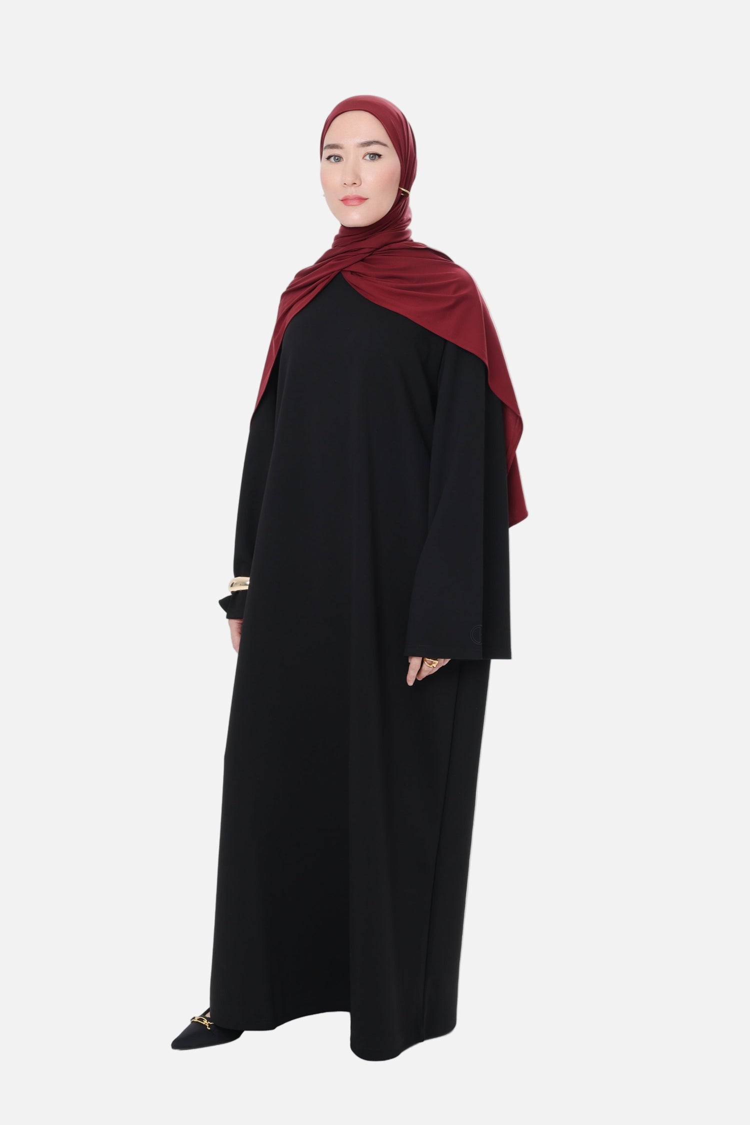 Front-side view of the Comfy Dress in Black, highlighting the modest silhouette and soft cotton-blend drape.