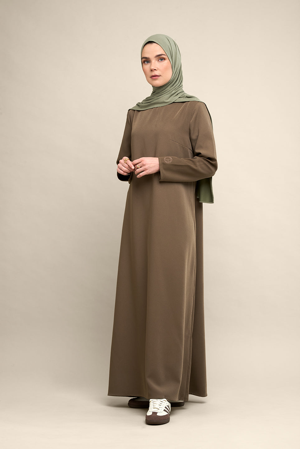Elevate your modest wardrobe with our elegant two-piece staple abaya set in brown taupe. This versatile set includes a long-sleeve dress with a discreet back zipper and a classic abaya overlay that drapes beautifully for a timeless look.
