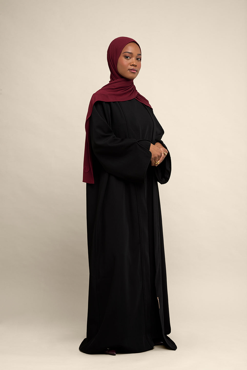Elevate your modest wardrobe with our elegant two-piece staple abaya set in black. This versatile set includes a long-sleeve dress with a discreet back zipper and a classic abaya overlay that drapes beautifully for a timeless look.