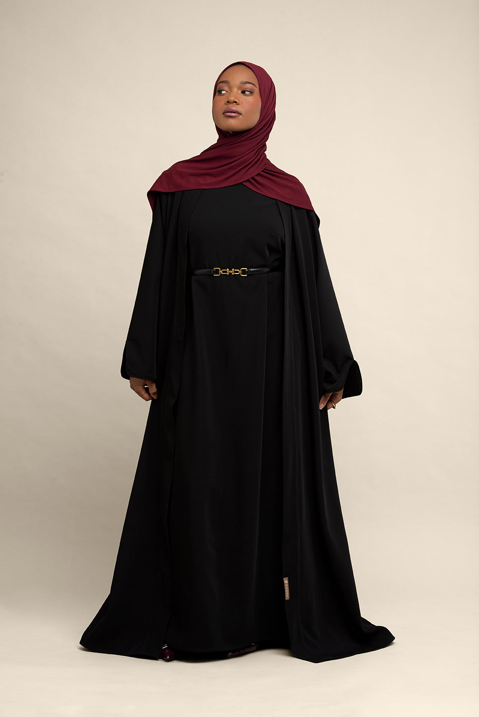 Elevate your modest wardrobe with our elegant two-piece staple abaya set in black. This versatile set includes a long-sleeve dress with a discreet back zipper and a classic abaya overlay that drapes beautifully for a timeless look.