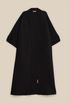 Elevate your modest wardrobe with our elegant two-piece staple abaya set in black. This versatile set includes a long-sleeve dress with a discreet back zipper and a classic abaya overlay that drapes beautifully for a timeless look.