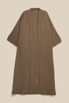 Elevate your modest wardrobe with our elegant two-piece staple abaya set in brown taupe. This versatile set includes a long-sleeve dress with a discreet back zipper and a classic abaya overlay that drapes beautifully for a timeless look.