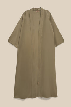 Elevate your modest wardrobe with our elegant two-piece staple abaya set in light sage. This versatile set includes a long-sleeve dress with a discreet back zipper and a classic abaya overlay that drapes beautifully for a timeless look.