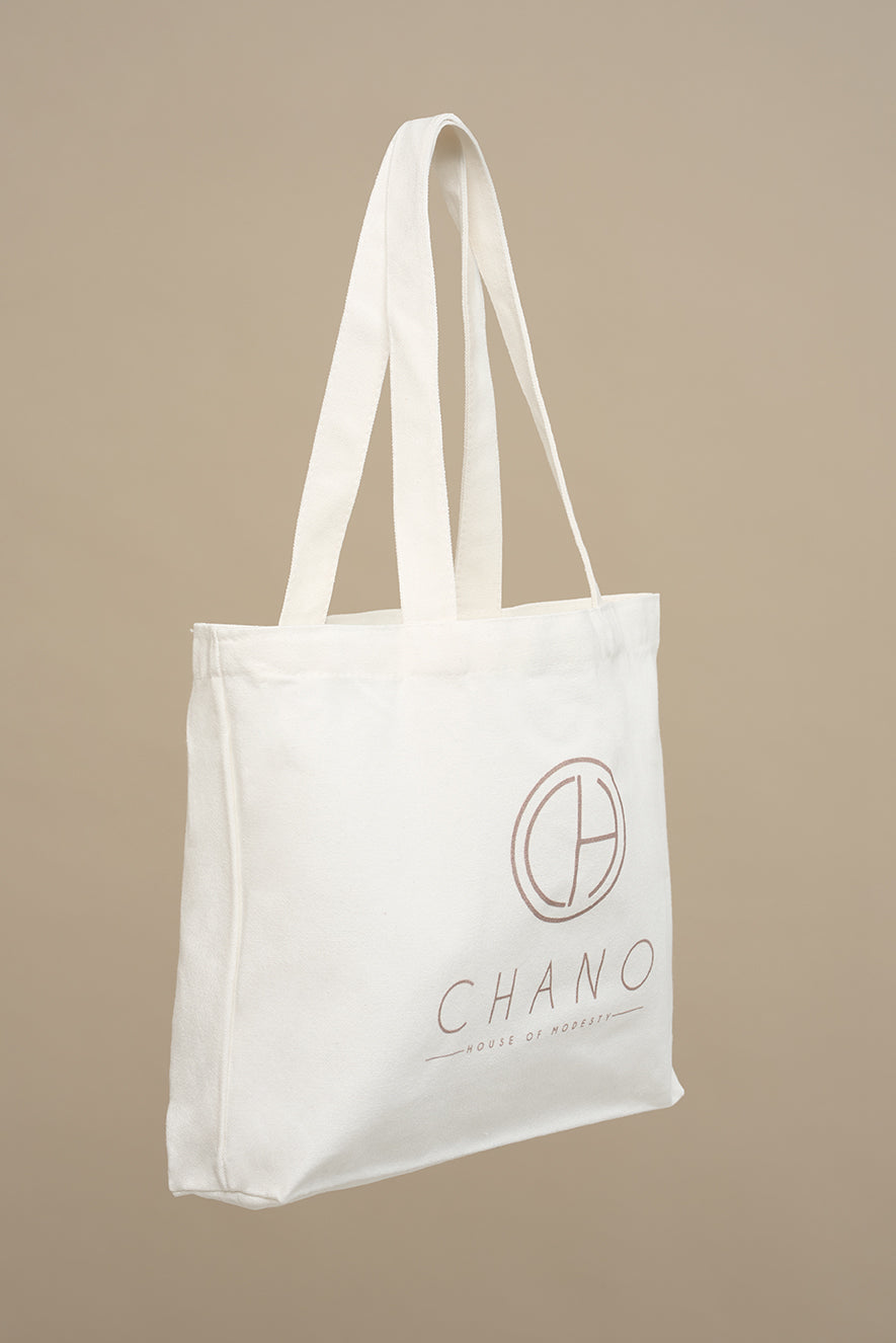 This tote bag is made from durable recycled cotton canvas, the bag features a spacious main compartment with a wide opening.