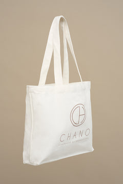 This tote bag is made from durable recycled cotton canvas, the bag features a spacious main compartment with a wide opening.