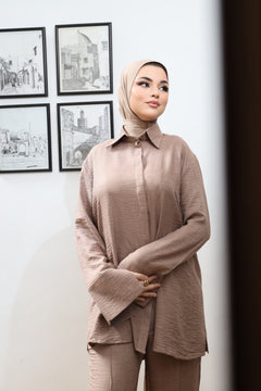 Close-up of soft brown textured modest two-piece set featuring a structured collar and flared sleeves, styled with bamboo instant hijab – part of CHANO Modesty’s spring/summer collection.