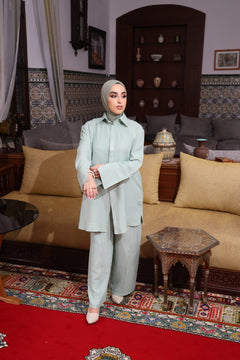 Modest fashion textured two-piece set in pastel green – loose-fit tunic and wide-leg pants styled with an instant bamboo hijab. 