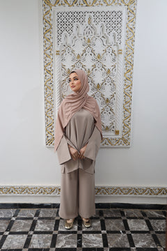 Full outfit view of a woman wearing a matching Taupe tunic and wide-leg trousers.