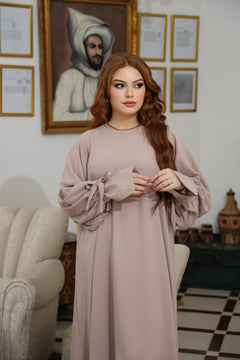 Close-up of the voluminous balloon sleeve on the CHANO Modesty dress in  Taupe, highlighting the soft fabric texture and gathered cuff detail.