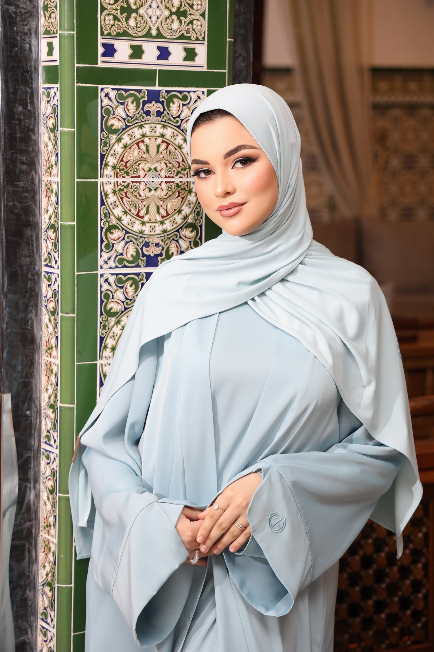 Close-up of the two-piece satin abaya in sky blue matched with the premium jersey stone in sky blue. 