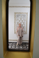 Model wearing a flowy Taupe twinset featuring an oversized tunic with wide sleeves and matching loose-fit trousers.