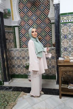 Full outfit view of a woman in a matching Blush Beige tunic and wide-leg trousers.