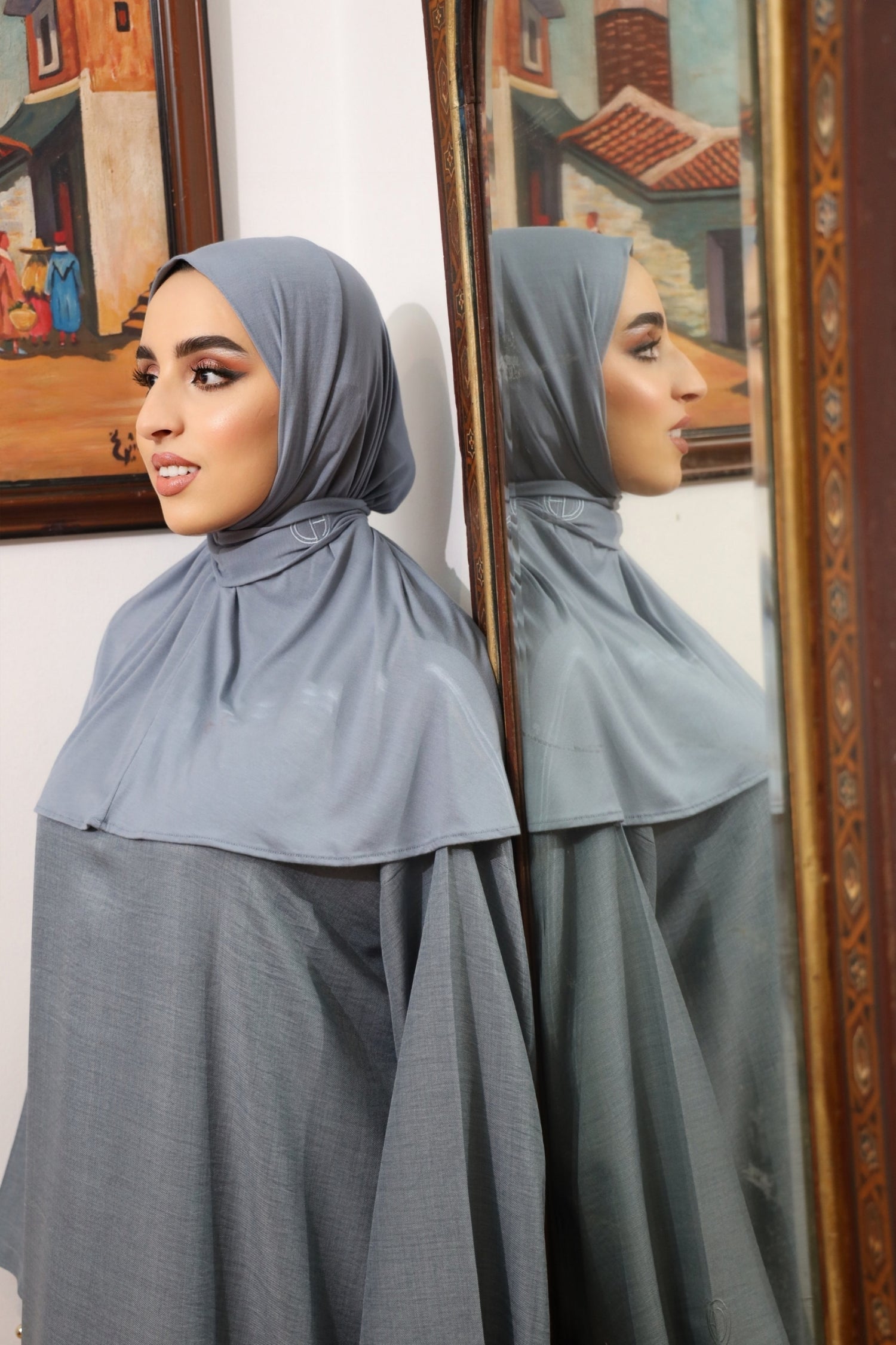 Close-up of woman wearing CHANO Modesty’s Instant Bamboo Hijab in dusty blue, featuring soft bamboo jersey fabric and embroidered logo — breathable and easy to style.