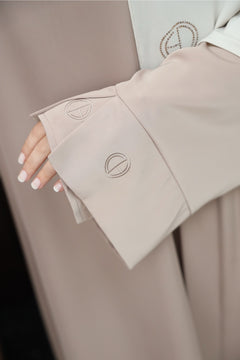 Embroidery sleeve of the taupe two-piece satin abaya. 