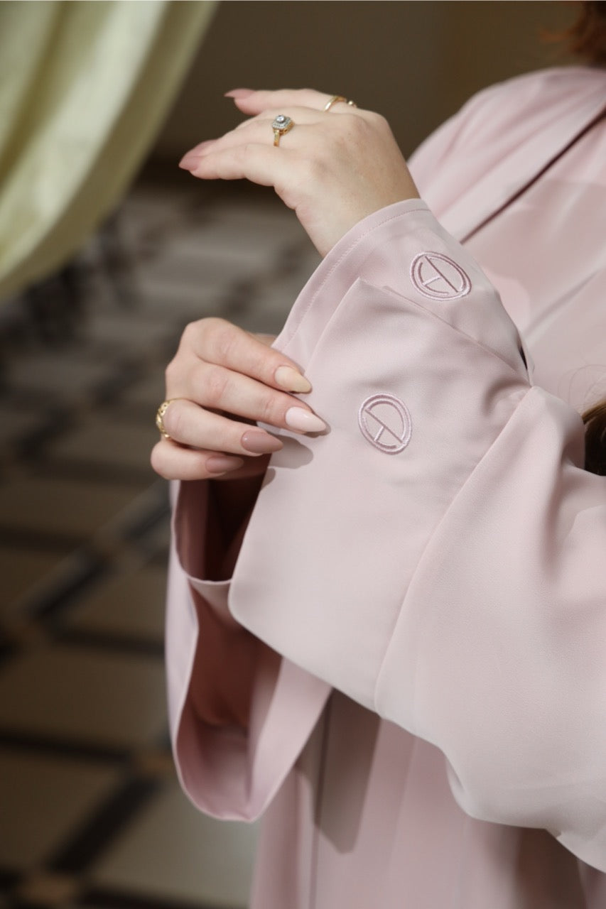 Embroidery sleeve of the soft pink two-piece satin abaya. 