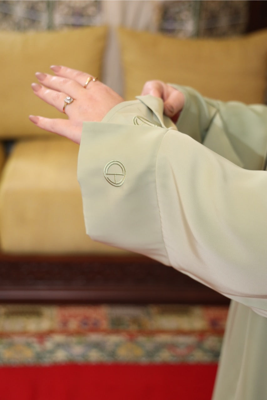 Embroidery sleeve of the soft green two-piece satin abaya. 