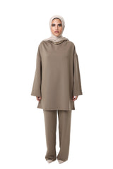 Model wearing the CHANO Comfy Two-Piece Set in Taupe — an oversized tunic with wide sleeves and matching wide-leg trousers, styled with a beige hijab.