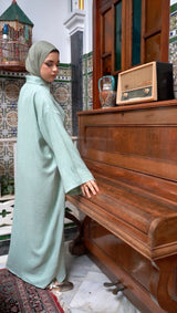 Model wearing CHANO Modesty’s Textured Tunic Dress in pastel green, a relaxed modest fit with wide sleeves and a buttoned collar — perfect for effortless elegance.