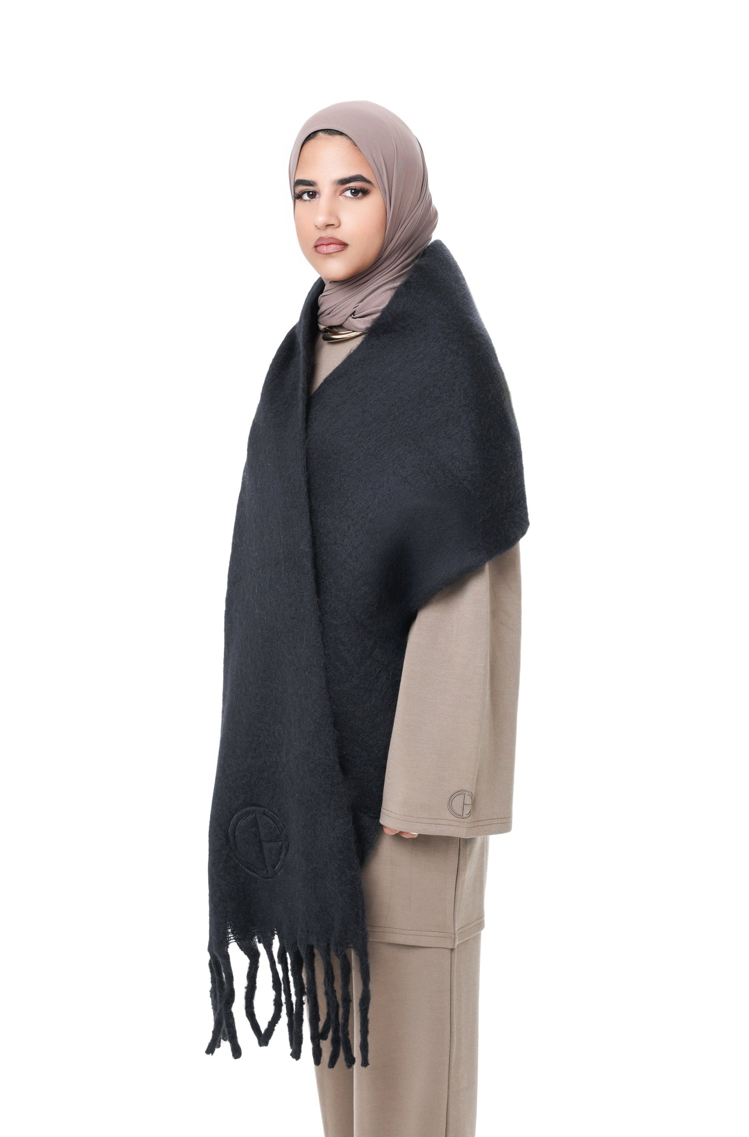 Side angle of the Comfy Scarf in Black, featuring long fringes and a cozy, voluminous drape.