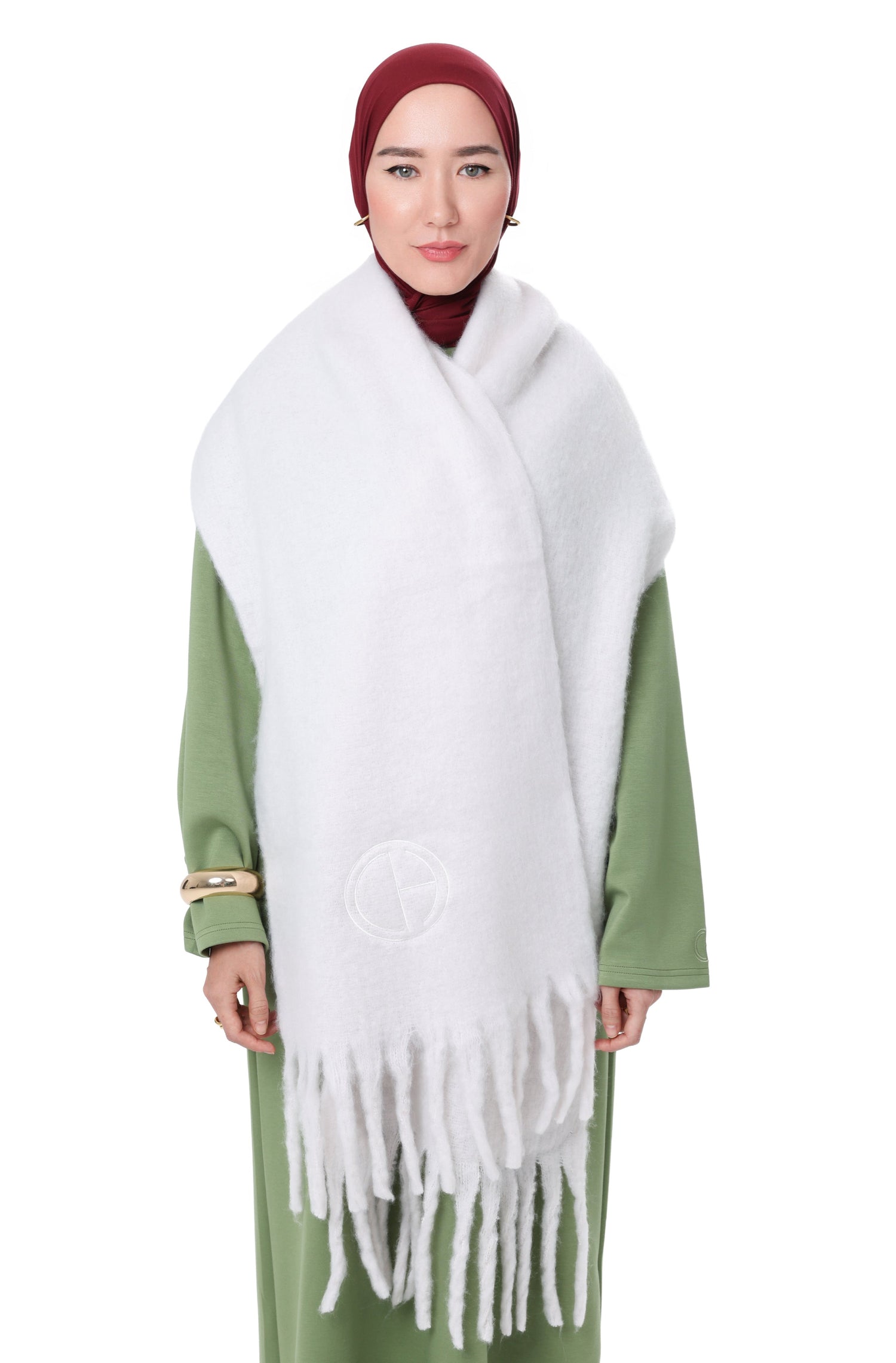 Front view of model wearing the Comfy Scarf in White, styled over the leaf comfy dress with a burgundy hijab, showcasing the soft brushed texture and fringe edges.