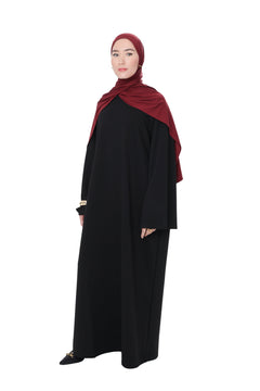 Front-side view of the Comfy Dress in Black, highlighting the modest silhouette and soft cotton-blend drape.