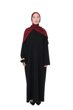 Full front view of the Comfy Dress in Black, paired with a burgundy hijab, showing the flowy, elegant fit.
