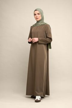 Elevate your modest wardrobe with our elegant two-piece staple abaya set in brown taupe. This versatile set includes a long-sleeve dress with a discreet back zipper and a classic abaya overlay that drapes beautifully for a timeless look.