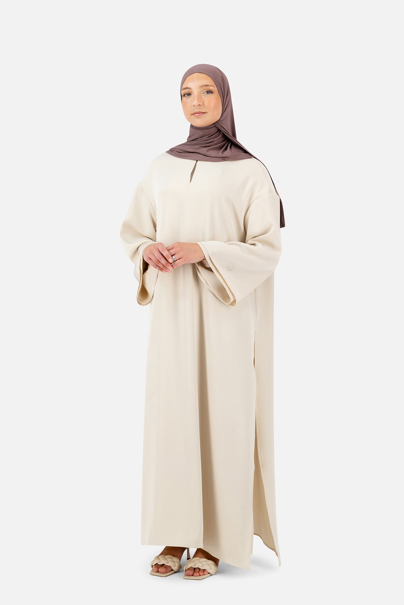 Modest two-piece abaya set in soft Rose Beige styled with matching hijab