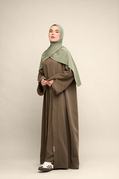Elevate your modest wardrobe with our elegant two-piece staple abaya set in brown taupe. This versatile set includes a long-sleeve dress with a discreet back zipper and a classic abaya overlay that drapes beautifully for a timeless look.