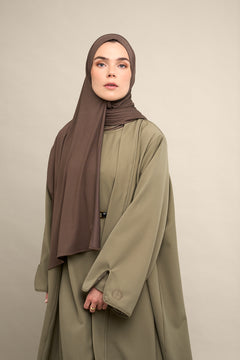Elevate your modest wardrobe with our elegant two-piece staple abaya set in light sage. This versatile set includes a long-sleeve dress with a discreet back zipper and a classic abaya overlay that drapes beautifully for a timeless look.