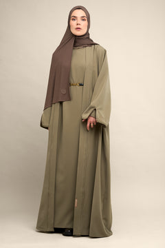 Elevate your modest wardrobe with our elegant two-piece staple abaya set in light sage. This versatile set includes a long-sleeve dress with a discreet back zipper and a classic abaya overlay that drapes beautifully for a timeless look.