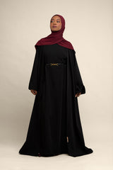 Elevate your modest wardrobe with our elegant two-piece staple abaya set in black. This versatile set includes a long-sleeve dress with a discreet back zipper and a classic abaya overlay that drapes beautifully for a timeless look.