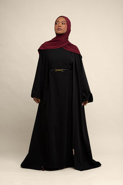 Elevate your modest wardrobe with our elegant two-piece staple abaya set in black. This versatile set includes a long-sleeve dress with a discreet back zipper and a classic abaya overlay that drapes beautifully for a timeless look.